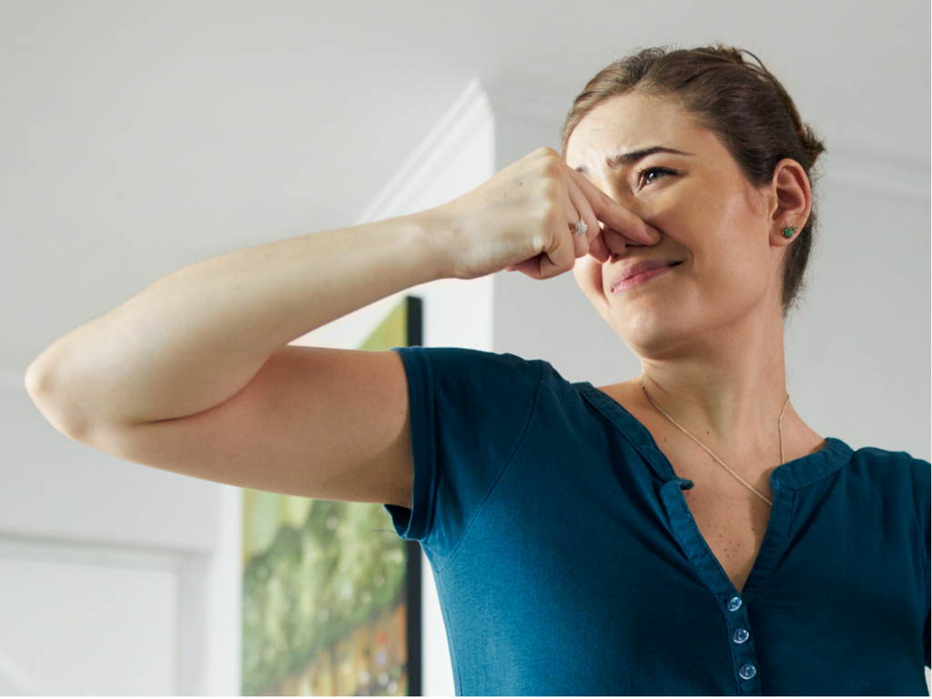 girl plugging nose